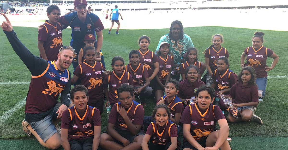 web unforgettable expereince lions.jpg Children from Cherbourg State School all smiles after Mitch Robinson presented them with their own Lions guernsey. - Brisbane Lions